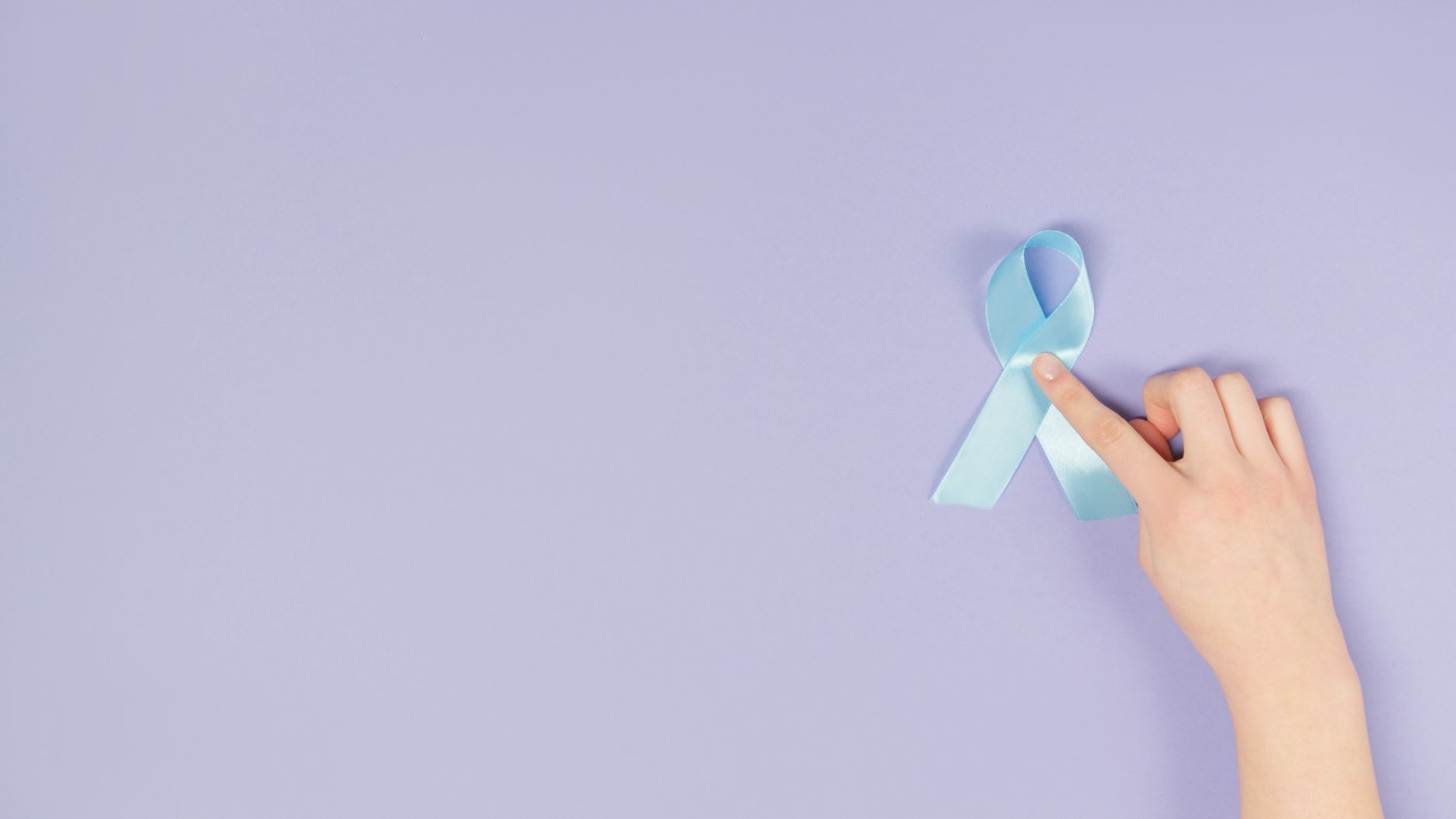 a hand touching a blue ribbon
